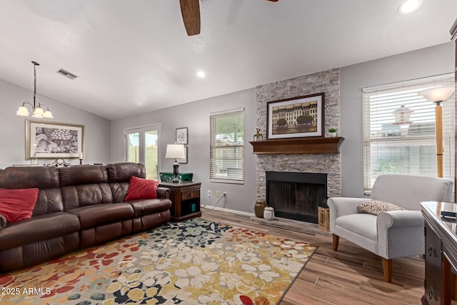 19 W Wickieup Ln, Phoenix, AZ 85027 - living area with a ceiling fan, lofted ceiling, plenty of natural light, light wood-style floors, and a stone fireplace