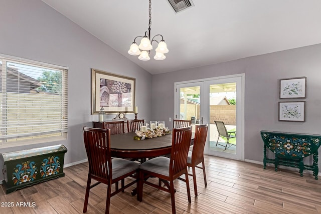 19 W Wickieup Ln, Phoenix, AZ 85027 - dining area featuring a chandelier, lofted ceiling, wood finished floors, and baseboards