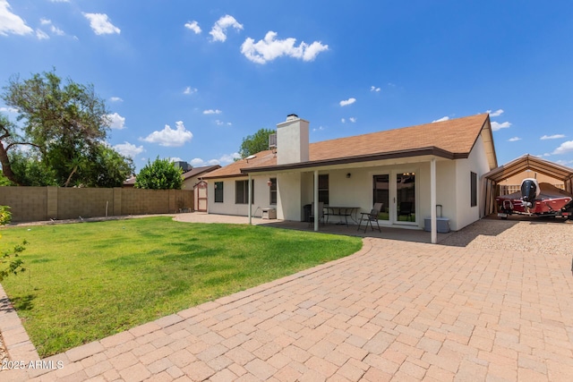 19 W Wickieup Ln, Phoenix, AZ 85027 - rear view of house featuring a chimney, stucco siding, and a patio