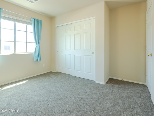2826 E Tracy Ln Unit 3, Phoenix, AZ 85032 - unfurnished bedroom featuring carpet, a closet, and baseboards