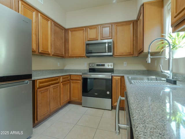 2826 E Tracy Ln Unit 3, Phoenix, AZ 85032 - kitchen with appliances with stainless steel finishes, a sink, brown cabinets, and light tile patterned flooring