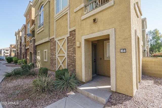 entrance to property featuring stucco siding