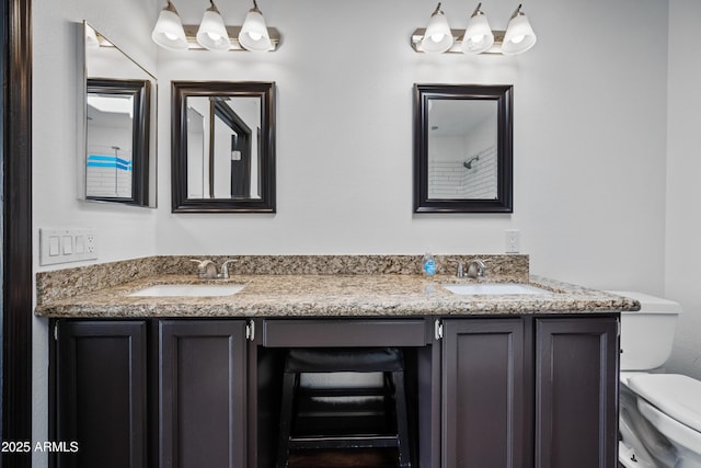 bathroom with toilet and double vanity