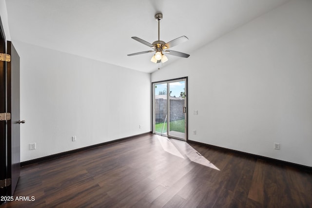 spare room featuring ceiling fan, wood finished floors, vaulted ceiling, and baseboards