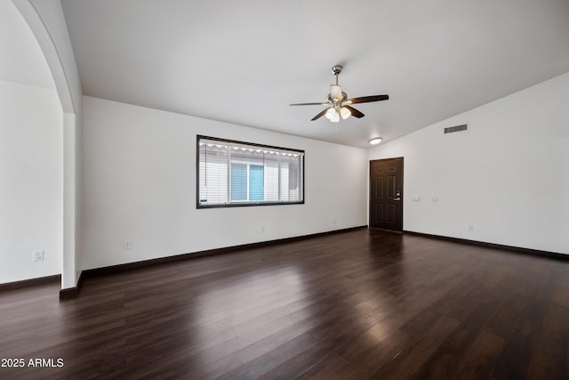 unfurnished room with a ceiling fan, lofted ceiling, dark wood-style flooring, and baseboards