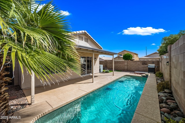 view of swimming pool featuring a patio area, a fenced backyard, and cooling unit