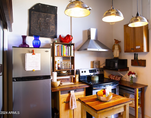 601 N Berry Ave, Winslow, AZ 86047 - kitchen with appliances with stainless steel finishes and wall chimney range hood