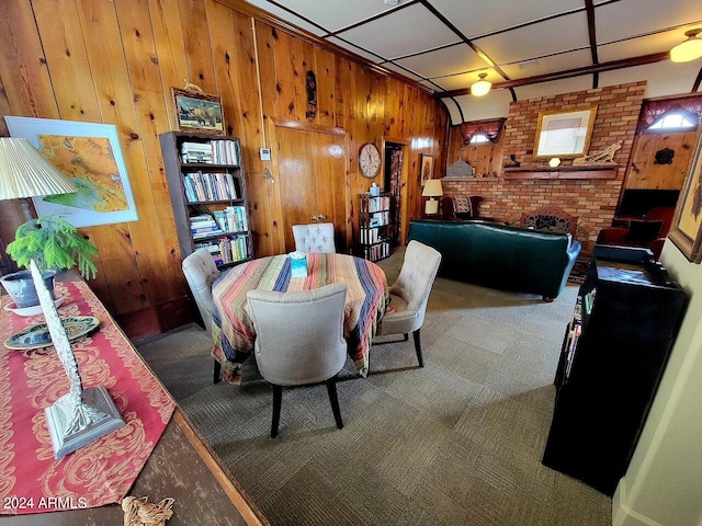 601 N Berry Ave, Winslow, AZ 86047 - dining area with wood walls, carpet floors, and a fireplace