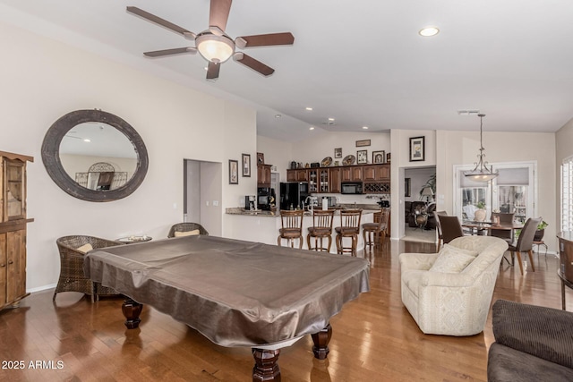 game room featuring lofted ceiling, recessed lighting, ceiling fan, wood finished floors, and billiards