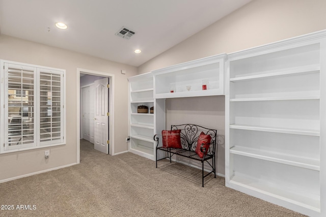 interior space featuring lofted ceiling, recessed lighting, visible vents, carpet flooring, and baseboards