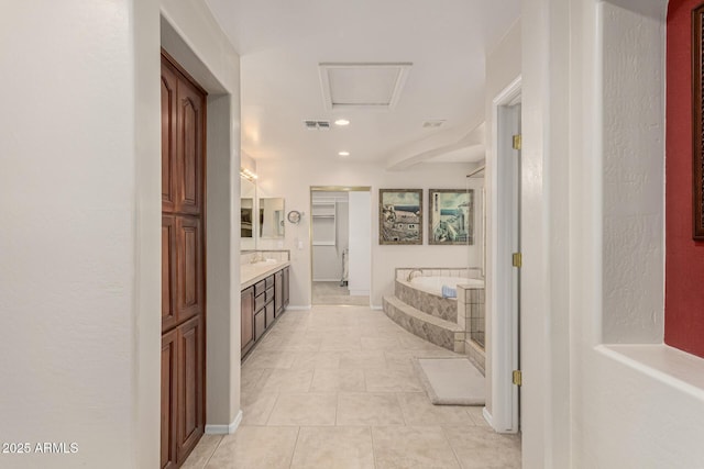 bathroom with a closet, visible vents, vanity, tile patterned flooring, and a bath