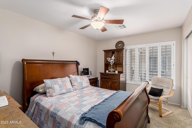 bedroom featuring light colored carpet, ceiling fan, visible vents, and baseboards