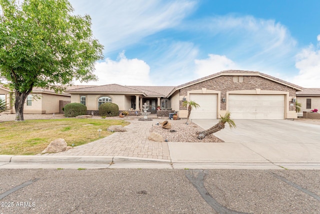 single story home with a garage, a front yard, concrete driveway, and stucco siding