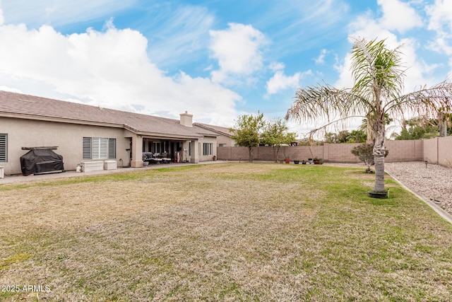 view of yard with a fenced backyard and a patio