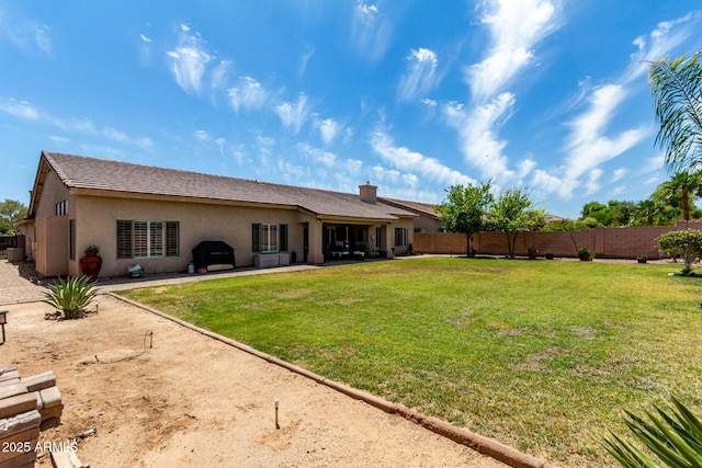 exterior space with a lawn, a patio, a fenced backyard, and stucco siding
