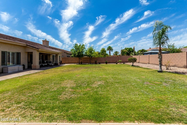 view of yard featuring a patio and a fenced backyard