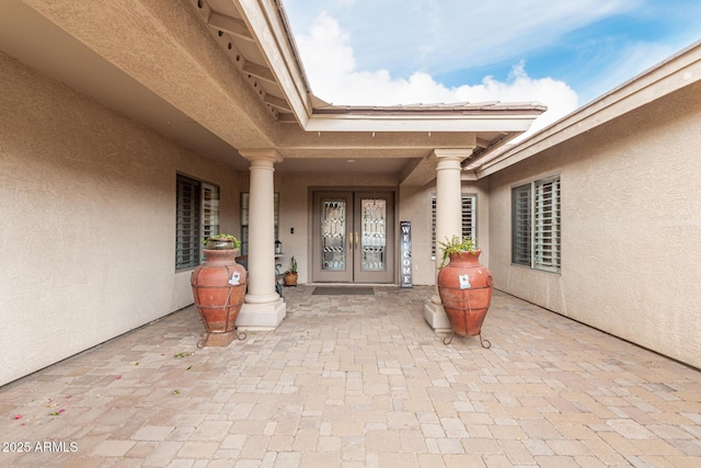 doorway to property with french doors and stucco siding