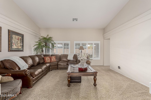 living area featuring carpet floors, baseboards, and visible vents