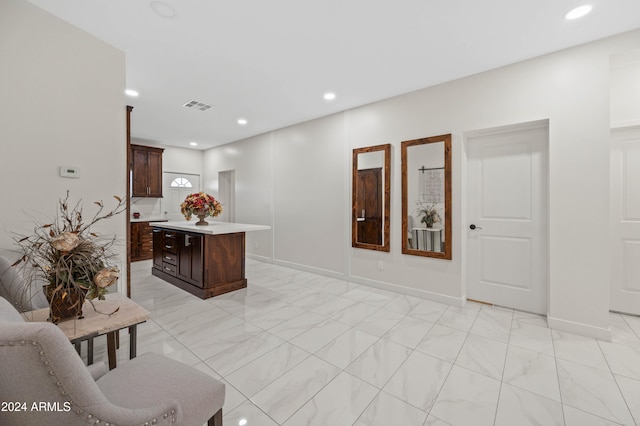 interior space featuring dark brown cabinetry and a kitchen island