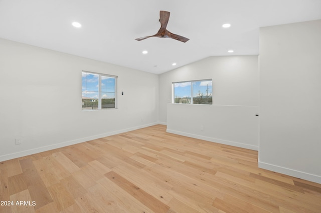 empty room featuring light hardwood / wood-style floors, lofted ceiling, and ceiling fan