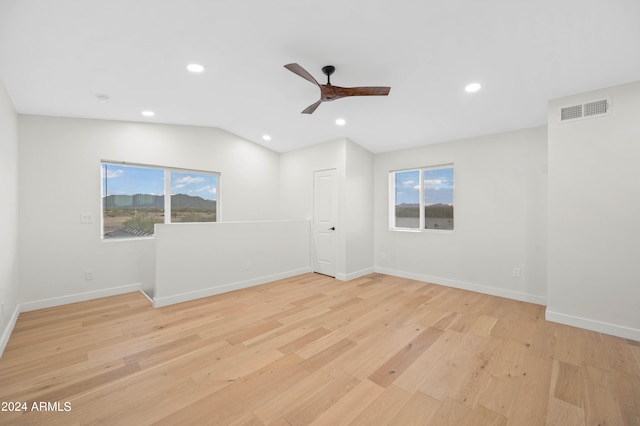 unfurnished room with vaulted ceiling, light hardwood / wood-style floors, and ceiling fan