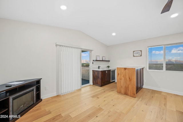 kitchen featuring vaulted ceiling and light hardwood / wood-style flooring