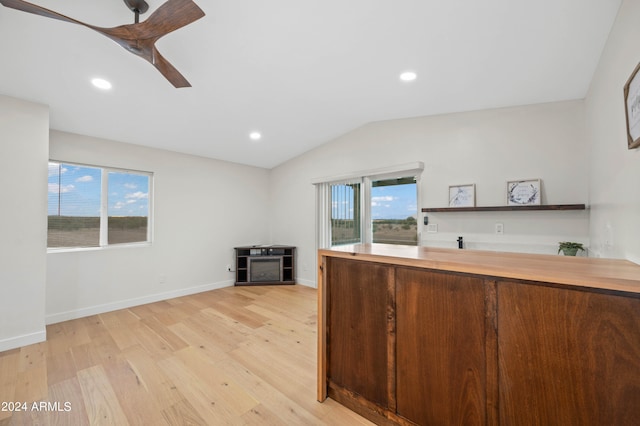 kitchen featuring vaulted ceiling and light wood-type flooring