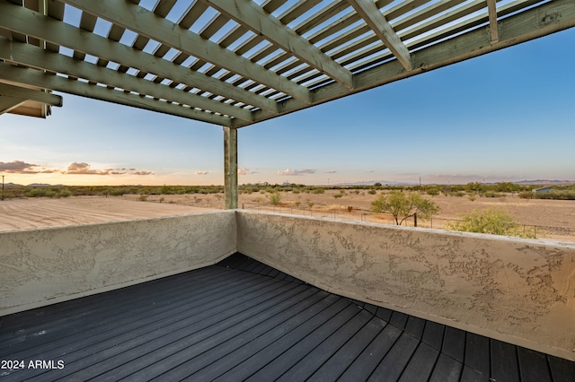 deck at dusk with a rural view and a pergola