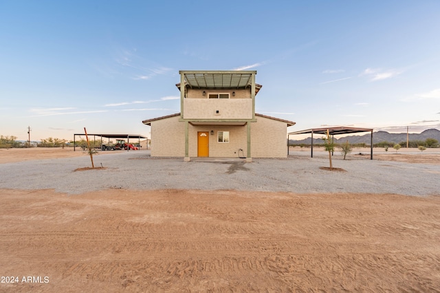 rear view of property featuring a carport and a mountain view