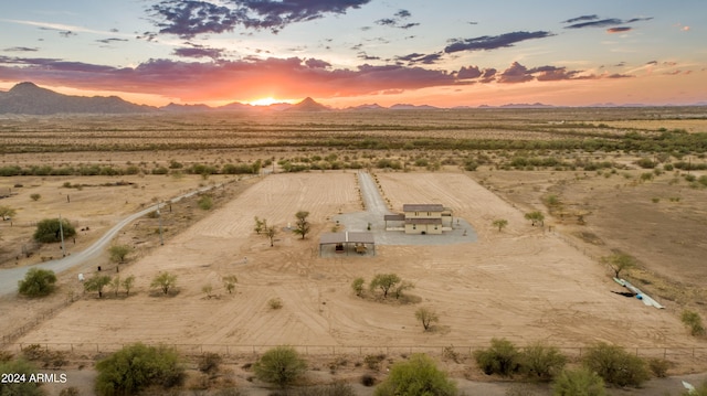 aerial view at dusk with a mountain view and a rural view