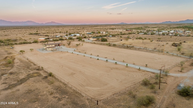 aerial view at dusk featuring a rural view and a mountain view