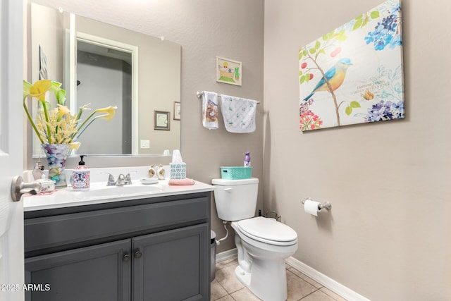 bathroom featuring toilet, vanity, and tile patterned flooring