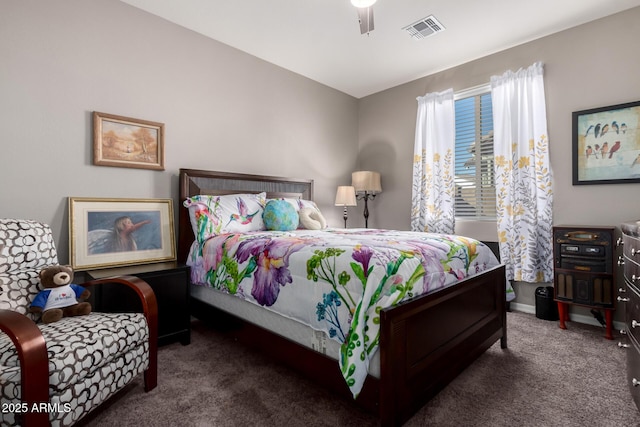 bedroom with ceiling fan and dark colored carpet