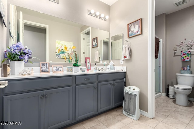 bathroom featuring toilet, tile patterned floors, and vanity