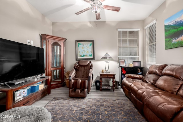 living room with ceiling fan and dark wood-type flooring