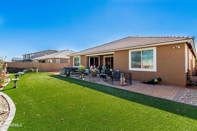 back of house with a patio area and a yard