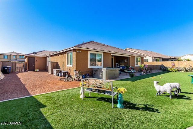 rear view of house with a patio area and a yard