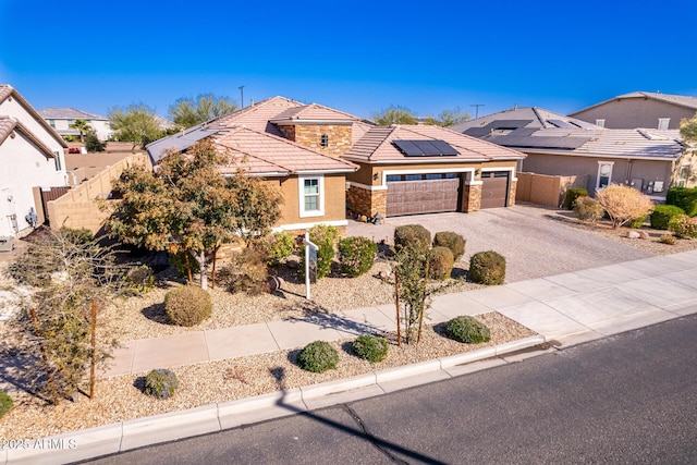 view of front of home with a garage and solar panels