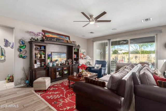 living room with ceiling fan and light hardwood / wood-style flooring