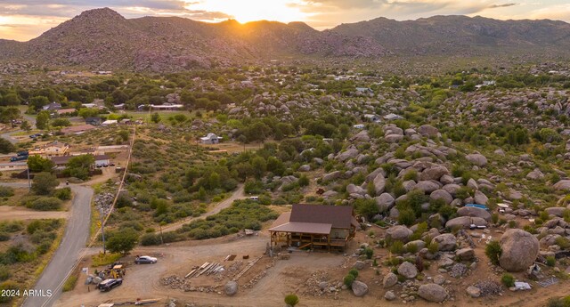 aerial view at dusk featuring a mountain view