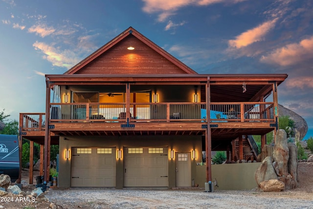 view of front facade with a wooden deck and a garage