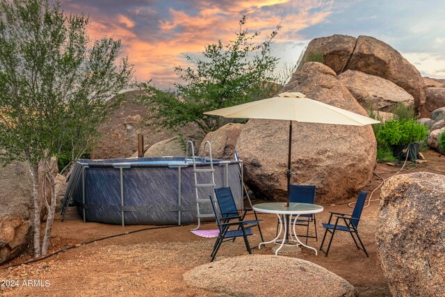 patio terrace at dusk featuring a mountain view