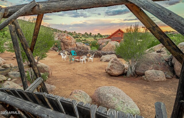 yard at dusk featuring a fire pit