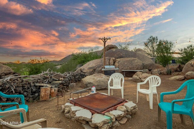 patio terrace at dusk with a grill