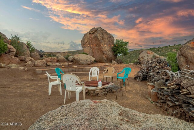 patio terrace at dusk with an outdoor fire pit