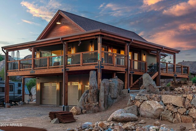 view of front facade featuring a wooden deck and a garage