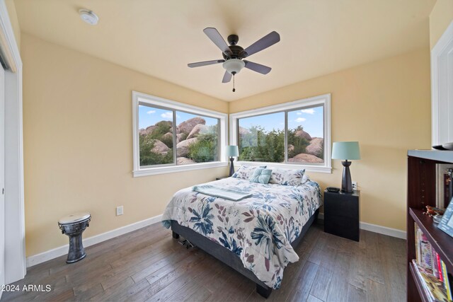 bedroom with dark hardwood / wood-style floors and ceiling fan