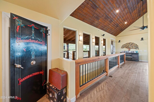 hallway featuring lofted ceiling, wood ceiling, and wood-type flooring