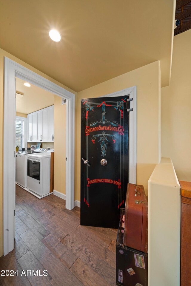 interior space featuring white cabinetry, washer / clothes dryer, and hardwood / wood-style floors