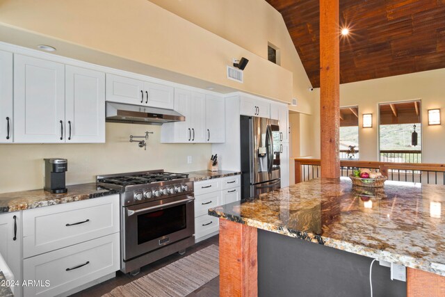 kitchen with white cabinetry, stainless steel appliances, and light stone countertops